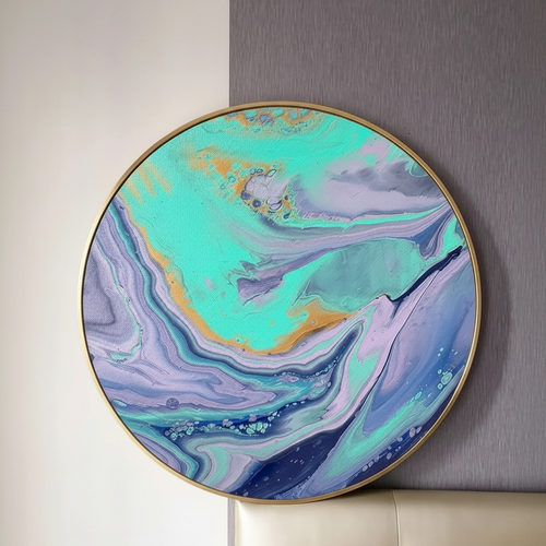 Round framed abstract wall art featuring swirling turquoise, purple, blue, and gold marbled patterns, displayed against a split beige and gray wall above a cream tufted sofa.